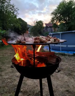 a grill with a tray of food on top of it at Къща за гости Аврамови in Ribarica