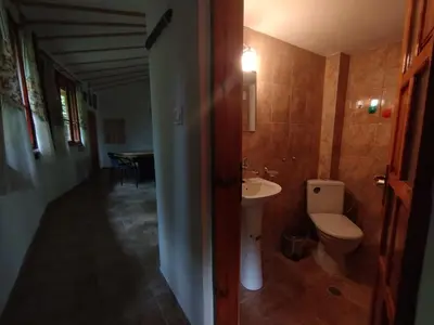 a bathroom with a toilet and a sink at Къща за гости Аврамови in Ribarica