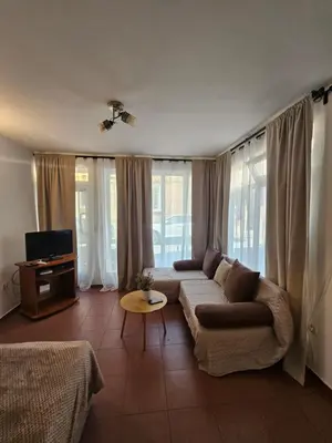 a living room with a couch and a tv at Charming Ground Floor Aprt In Old Sofia in Sofia
