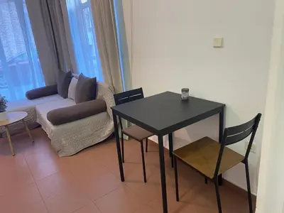 a living room with a table and a couch at Charming Ground Floor Aprt In Old Sofia in Sofia