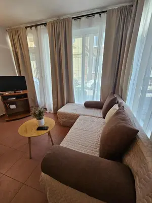 a living room with a couch and a table at Charming Ground Floor Aprt In Old Sofia in Sofia