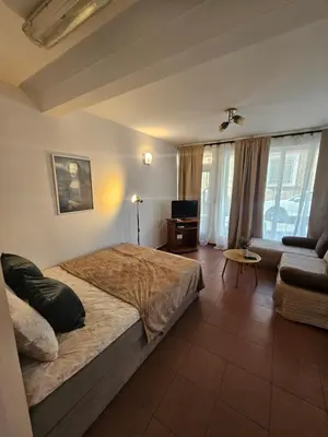 a bedroom with a large bed and a couch at Charming Ground Floor Aprt In Old Sofia in Sofia
