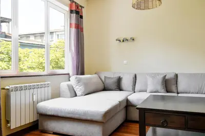 a living room with a couch and a table at Modern 2BD Flat in Central Sofia with Workspace by Flat Mаnager in Sofia
