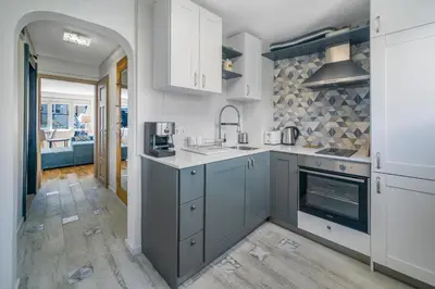 a kitchen with white cabinets and a sink at Charming Downtown Apartment with Unique Terrace in Sofia