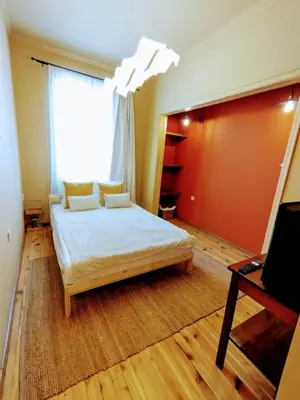 a bedroom with a bed and a large window at Moon House Red in Plovdiv