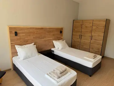two beds in a room with two towels on them at By The River in Plovdiv