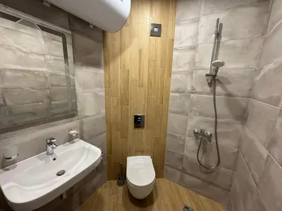 a bathroom with a sink and a toilet and a shower at By The River in Plovdiv