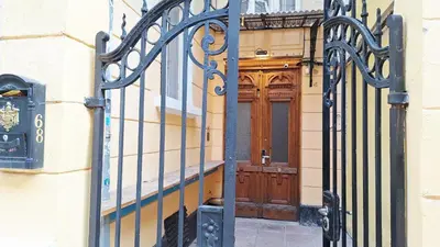 a gate to a building with a wooden door at Key Hostel Vitosha in Sofia