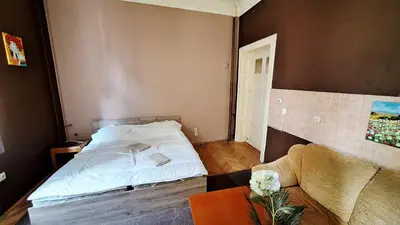 a bedroom with a bed and a table and a couch at Key Hostel Vitosha in Sofia