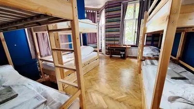 a room with three bunk beds and a desk at Key Hostel Vitosha in Sofia