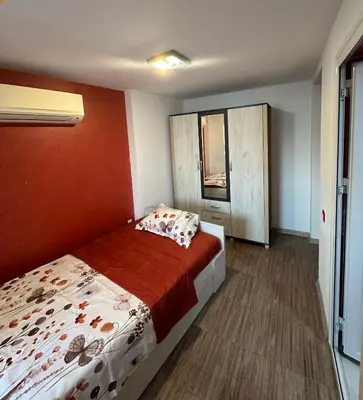 a small bedroom with a bed and a window at Guest Rooms Comfort 2 in Plovdiv