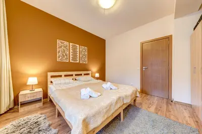 a bedroom with a large bed with towels on it at Cosy1BD Apt with a Free Parking and Balcony - Grand Resort Pamporovo by Flat Manаger in Pamporovo