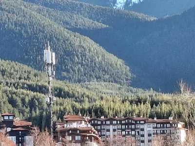 a group of buildings in front of a mountain at Илен C411 Panorama Resort Bansko in Bansko
