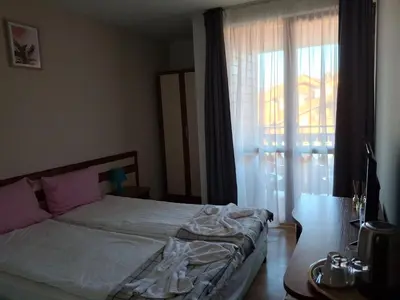 a bedroom with a bed and a large window at Илен C411 Panorama Resort Bansko in Bansko