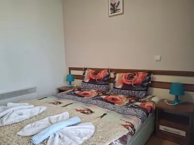 a bedroom with a bed with towels on it at Илен C411 Panorama Resort Bansko in Bansko