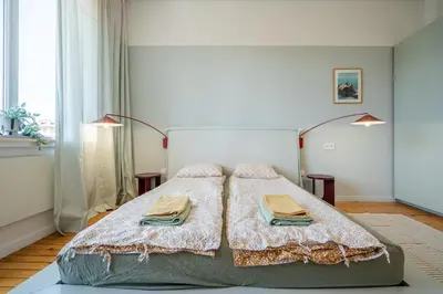 a bedroom with a large bed with two towels on it at Bright & Central 2BR in Historic Heart of Sofia in Sofia
