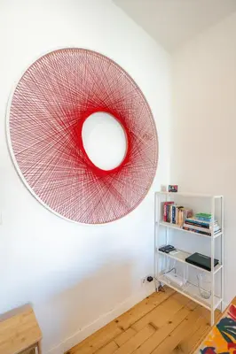 a large red artwork on the wall of a room at Bright & Central 2BR in Historic Heart of Sofia in Sofia