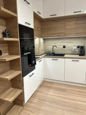 a kitchen with white cabinets and a black appliances at K&D Alpine Getaway , Cozy Stay in Bansko