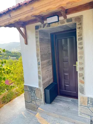 a door on the side of a house with a view at Cozy Home in Ardino 2 in Ardino