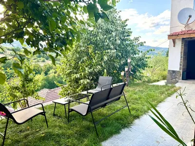 a group of chairs sitting in the grass at Cozy Home in Ardino 2 in Ardino