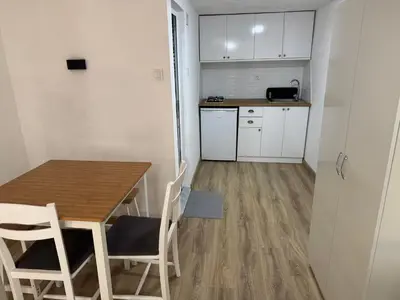 a small kitchen and dining room with a table and chairs at Cozy Home in Ardino 2 in Ardino