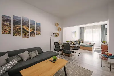 a living room with a couch and a dining room at Grand Luxury Condo by NDK and National Stadium with Free Security Parking in Sofia