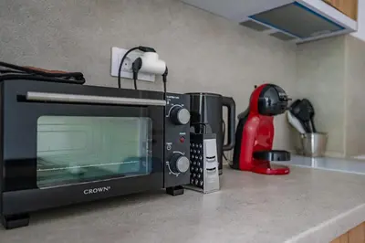 a kitchen counter with a microwave on a counter top at Grand Luxury Condo by NDK and National Stadium with Free Security Parking in Sofia