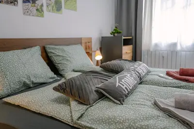 a bed with two pillows on top of it at Grand Luxury Condo by NDK and National Stadium with Free Security Parking in Sofia
