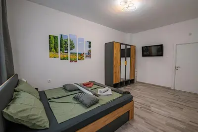 a bedroom with a bed and a television in it at Grand Luxury Condo by NDK and National Stadium with Free Security Parking in Sofia