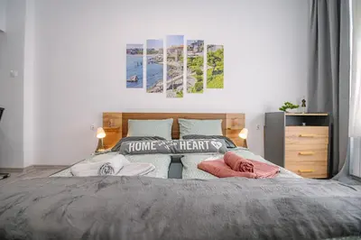 a bedroom with a bed with two pillows on it at Grand Luxury Condo by NDK and National Stadium with Free Security Parking in Sofia