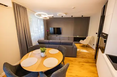 a living room with a table and a couch at Alpine Escape Design apartment Detelina Residence in Bansko