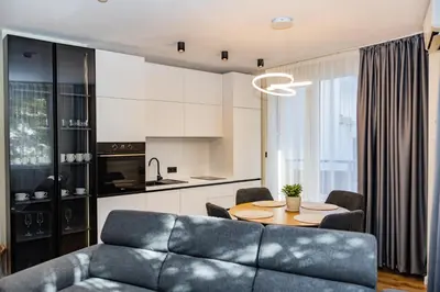 a living room with a couch and a table at Alpine Escape Design apartment Detelina Residence in Bansko