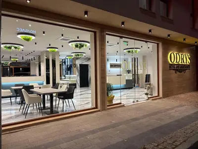a store window with tables and chairs in a store at Hotel Odrys in Plovdiv
