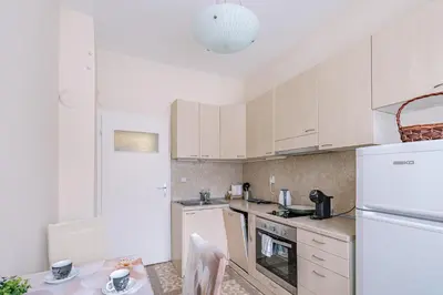a kitchen with white cabinets and a white refrigerator at Two Luxury Condos by NDK and National Stadium with 2 Free Parking Spots in Sofia