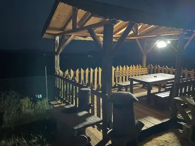 a wooden pergola with a picnic table on a deck at Studio Elias in Zlatograd