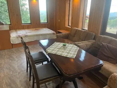 a living room with a table and a couch at Studio Elias in Zlatograd