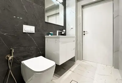 a bathroom with a white toilet and a sink at Designer 2BD Apt Near Alexander Nevski Cathedral by Flat Mаnager in Sofia
