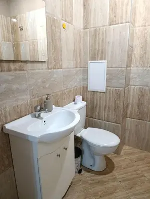 a bathroom with a white sink and a toilet at Mladost the City of Fountains Vitosha View in Sofia