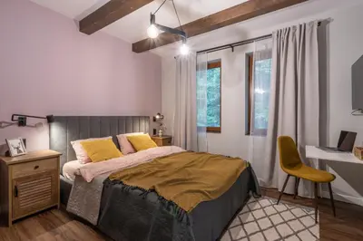a bedroom with a bed and a desk and a chair at 3 Спални - Електрическо Подово Отопление - Бърз WiFi - Веранда - В Гората - Warm Forest Nest Pamporovo in Pamporovo