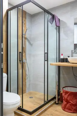 a shower with a glass door in a bathroom at Iva's Dream Studio, Crafted with Love and Passion in Bansko