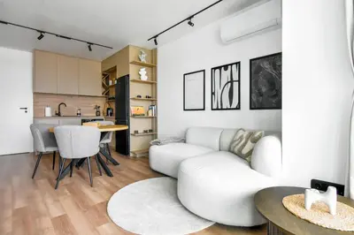 a living room with a white couch and a table at Modern & Quiet 1BR Near Center by Flat Mаnager in Sofia