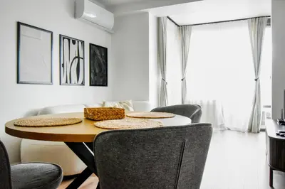 a dining room with a table and chairs at Modern & Quiet 1BR Near Center by Flat Mаnager in Sofia