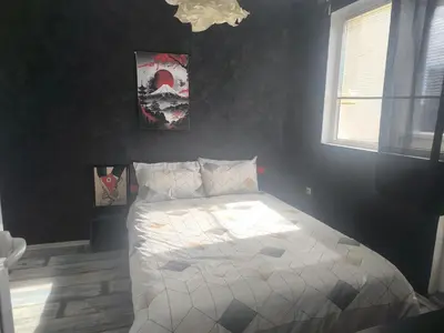 a bedroom with a white bed with a window at Sunny Hollow in Sofia