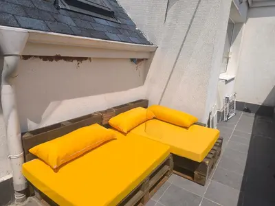 a yellow bench sitting on the side of a building at Sunny Hollow in Sofia