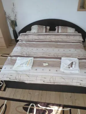 a large wooden bed in a room at Guest House Jani in Trigrad