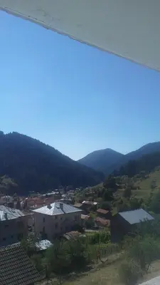 a view of a town with mountains in the background at Guest House Jani in Trigrad