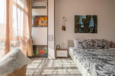 a bedroom with a bed and a window at Cozy Studio in Sofia