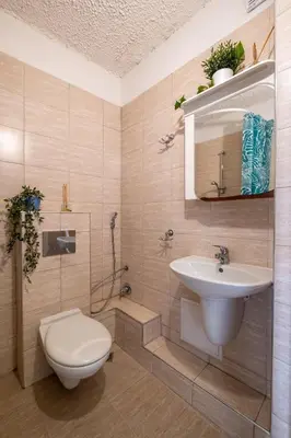 a bathroom with a toilet and a sink at Cozy Studio in Sofia