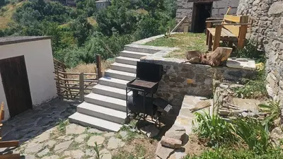 a set of stairs leading up to a building at Къща Сливови in Bŭnzareto