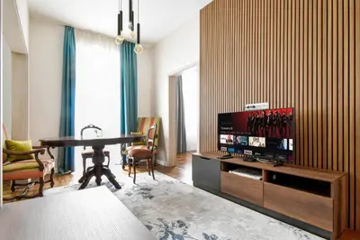 a living room with a television and a dining room table at Blue Breeze Apartment by Flat Mаnager in Sofia